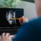 Medical professional reviewing knee mri images on a laptop, pointing at the joint detail with a pencil during a consultation